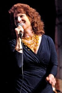 Vocalist Pamela Rose holding a microphone