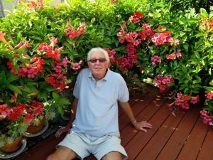 Opal Louis Nations sitting amid flowers