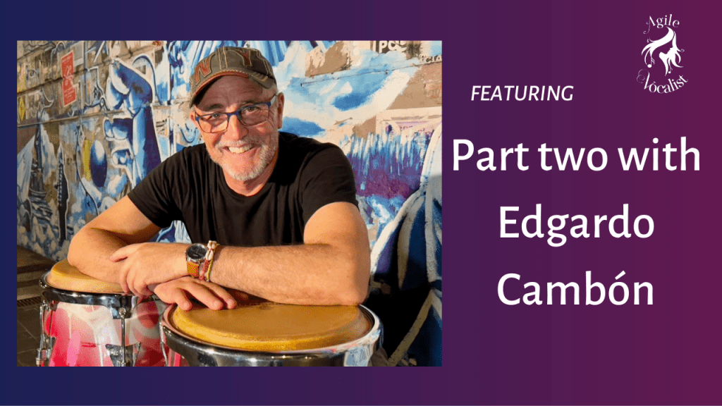 Man leaning forward on conga drum wearing hat and glasses Part 2 with Edgardo Camboon.