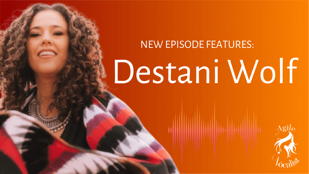 Woman with brown curly hair facing camera wearing black white and red Mexican shawl. Text: New episode featuring Destani Wolf. White Agile Vocalist logo. 