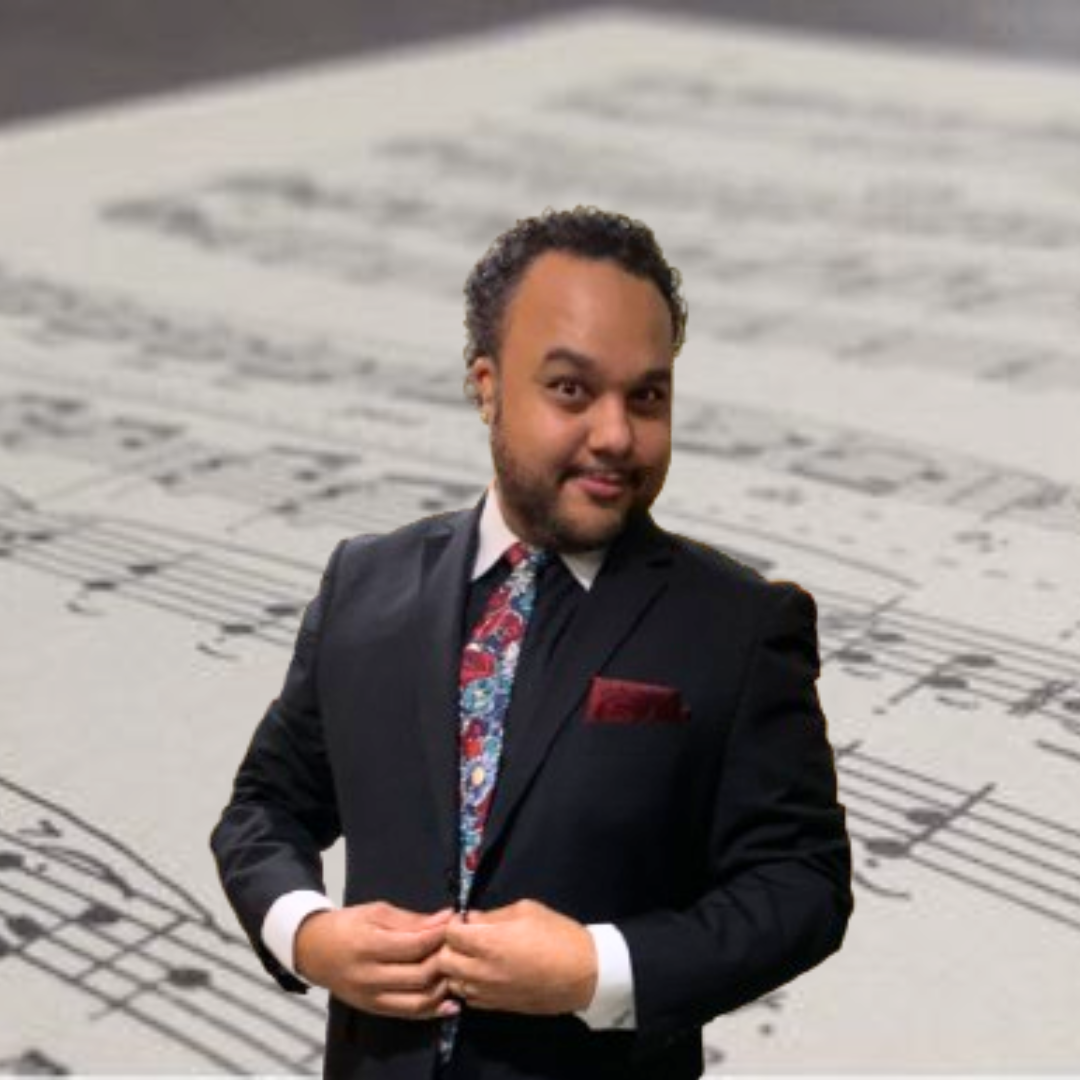 Alex Promo Opera Man smiling and clasping his hands on his suit jacket lapels against a background of sheet music.